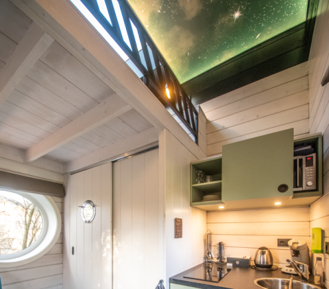 Interieur van glamping-accommodatie met sterrenhemelplafond bij Erfgoed Bossem - Sterrenkubussen Twente.
