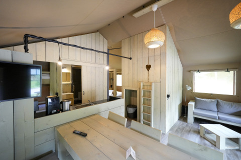 Interior view of glamping accommodation at Serengeti Park Tongasoa Lodges, Lower Saxony, featuring wood decor.