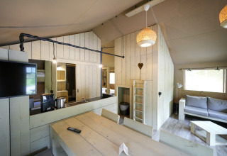 Interior view of glamping accommodation at Serengeti Park Tongasoa Lodges, Lower Saxony, featuring wood decor.