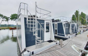 Woonboten met dakterras aangemeerd bij Marina Parcs Amsterdam, vakantiepark in Noord-Holland, Nederland.