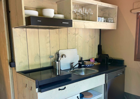 Cucina glamping moderna a Urban Gardens Ieper con pannelli in legno, lavastoviglie e scaffali aperti.