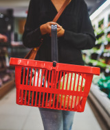 Supermarket - woman walks with shopping cart