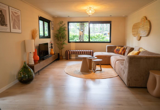 Cozy living room with modern decor at Camping Twente - Chalet Overijssel glamping accommodation in the forest.