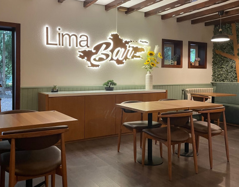 Interior of Lima Escape Glamping in Portugal featuring cozy seating, wooden tables, and modern decor.