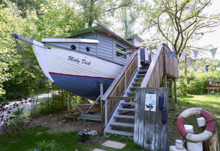 Glamping-accommodatie in de vorm van een boot genaamd 'Baumschiffhotel - Boomschepen Beieren' met trap.