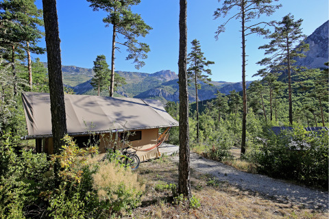 Luksustelt og hængekøje i skovklædt område med bjerge ved Huttopia Gorges du Verdon i Alpes-de-Haute-Provence.