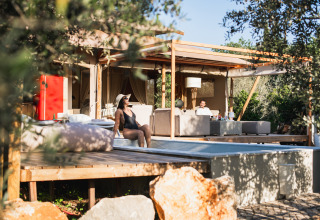 Alojamiento glamping Lodge Lua en Algarve, Portugal, con terraza elegante y huéspedes disfrutando al aire libre.
