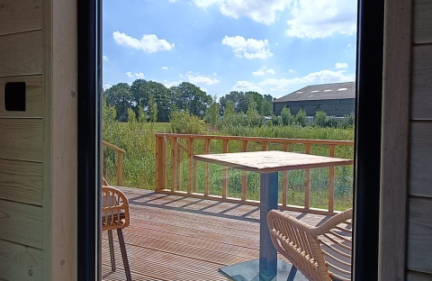 View from glamping accommodation at Stadslandgoed De Heicohoeve, Pipowagens Gelderland, terrace and landscape.