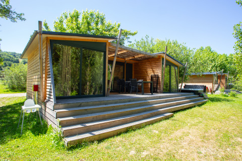 Moderne glampingindkvartering i træ med stor terrasse og naturudsigt på Camping Détente et Clapotis.