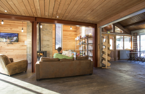 Salon convivial en bois dans les Huttopia Winter Chalets Bourg St Maurice, hébergement glamping en Savoie.