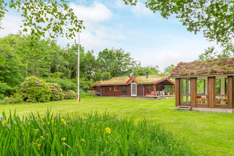 Ferienhaus in Roslev, Dänemark mit Grasdach, großem Garten, Blumen und umgeben von grüner Natur