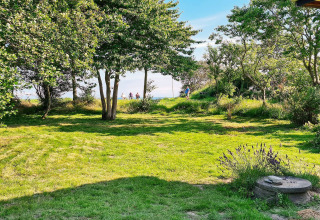 Jardin vert avec arbres et soleil près du lodge '5 star holiday home in Sydals', Danemark.