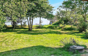 Jardín verde con árboles y césped cerca de la casa '5 star holiday home in Sydals', Dinamarca.