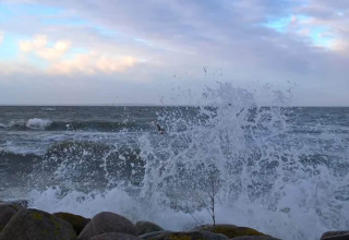 Las olas rompen contra las rocas en la orilla cerca de una casa de vacaciones para 6 personas en Bogense, Dinamarca.