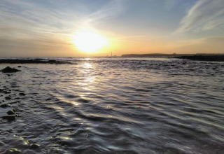 Sunset view from the coast at 4 star holiday home in Rønde, Denmark, with calm sea and scenic sky.