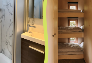 Foto de baño de cabaña con diseño de mármol y zona de literas triples con ventanas al exterior.