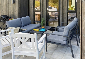 Outdoor patio with modern seating and barbecue at 5 star holiday home in Stokmarknes, Sweden.