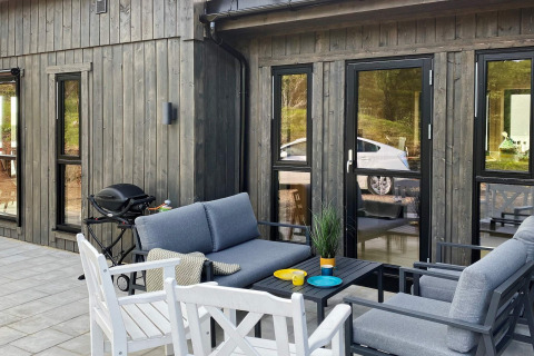 Terrazza accogliente di una casa vacanze a 5 stelle a Stokmarknes, Svezia, con arredi moderni e barbecue.