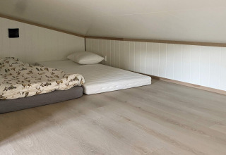 Et simpelt loftværelse i hytten 5 star holiday home in stokmarknes i Sverige, med madrasser på gulvet.
