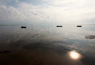 Eau calme reflétant le ciel et des bateaux à l’horizon au 5 star holiday home in Læsø, Danemark.