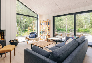 Modern living room in a 5 star holiday home in Læsø, Denmark, with large windows and scenic views.