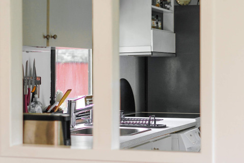 Zicht op een moderne keuken met spoelbak, messenhouder en grijze kasten in Holbæk, Denemarken.