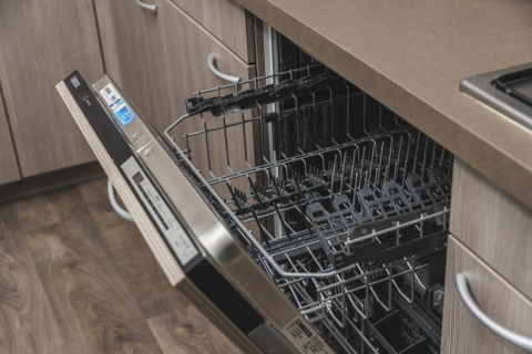 Open dishwasher in a modern kitchen at Cosy cabin, Vakantiepark Hölte, Netherlands, ready for loading.