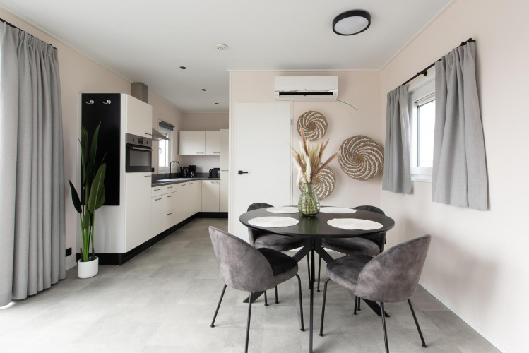 Modern dining and kitchen space at Wood Lodge with air conditioning, Kompas Camping Nieuwpoort, Belgium.