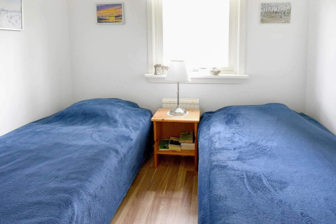Bright bedroom at 4 person holiday home in Frändefors, Sweden, with two single beds and blue covers.