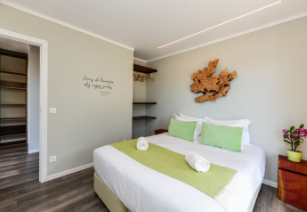 Dormitorio moderno en Dome House Duplex, Wecamp Reserva Alecrim, Portugal, con detalles verdes y decoración natural.