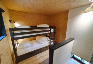 Cozy bunk bed room with wooden walls at Village de Vacances Oignies 5, Belgium, featuring modern decor.
