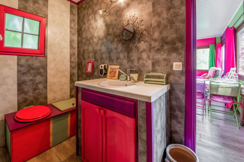 Colorful and artistic bathroom inside the yurt 'La Pause Insolite' with unique decor in Belgium.