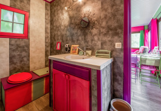 Colorful and artistic bathroom inside the yurt 'La Pause Insolite' with unique decor in Belgium.