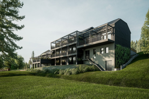 Moderne glampingaccommodatie met ruime terrassen en veel groen, gelegen op een glooiende heuvel.
