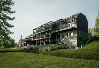 Moderne glampingaccommodatie met ruime terrassen en veel groen, gelegen op een glooiende heuvel.