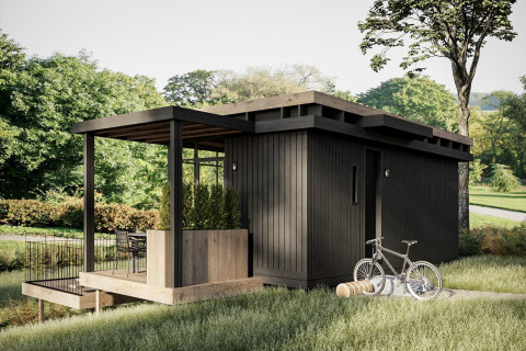 Moderne zwarte houten cabin bij Hillview Resort Grandvoir 1 in België met terras, fiets en groene natuur.