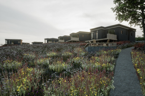 Moderne zwarte hutten bij Hillview Resort Grandvoir 1 in België, omgeven door wilde bloemen en paden.