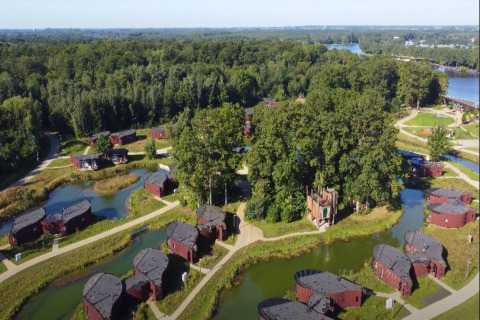 Aerial view of The TreeLoft by YourNature in Belgium, surrounded by forest, ponds, and unique cabins.