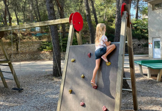 A child climbs on the playground climbing wall at Campsite La Vallée Heureuse in Provence-Alpes-Côte d’Azur, France.