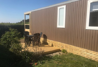 Terrasse extérieure avec chaises au Mobile home «Premium LIVING» au Flower Camping La Pointe du Talud, France.