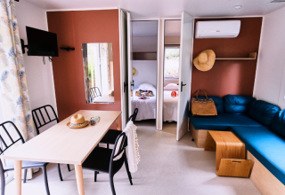 Bright, modern interior of Mobile Home Premium at Campsite La Vallée Heureuse, France, with cozy furnishings.