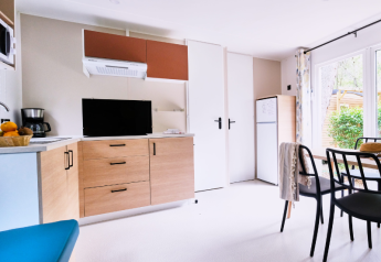 Helles und modernes Mobilheim-Küche und Wohnzimmer im La Vallée Heureuse Campingplatz in Frankreich.