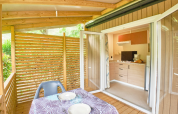 Mobile Home Premium at Campsite La Vallée Heureuse in France, featuring a cozy terrace and kitchen area.
