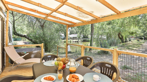 Colazione in terrazza al Zen Mobile Home di Ushuaïa Villages Le Parc de la Grève immersi nel verde.