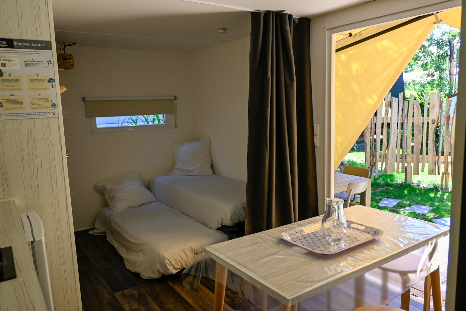 Binnenaanzicht van Cocosweet Ecolodge in Ushuaïa Villages Le Parc de la Grève, Frankrijk, met bedden en tafel.