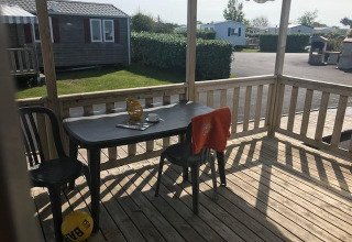 View from a wooden deck at mobile home Comfort PMR HELIOS in Flower Camping La Pointe du Talud, France.