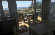 View from inside Mobile home «Premium LIVING» at Flower Camping La Pointe du Talud, terrace and ocean.