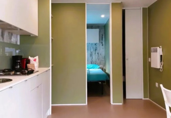 Cocina y sala modernas en Cottage Next XL Loggia Laguna en Trasimeno Glamping Resort en Italia.