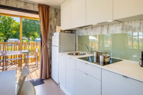 Cocina moderna en Cottage Next XL Loggia Laguna en Trasimeno Glamping Resort, vista a terraza exterior