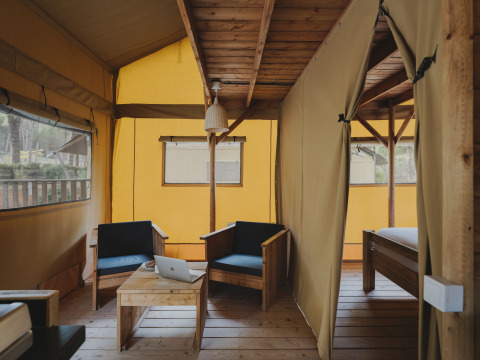 Binnenkant van de Lodge Duplex Plus Montgrí safaritent bij Wecamp L'Escala Punta Mila met houten meubilair.